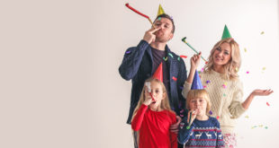 Family blowing party trumpets