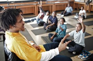 Students learn the benefits of yoga at Holistic Life Foundation 