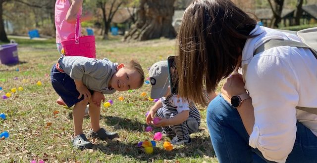 18-month-old looks at eggs he found in Easter egg hunt