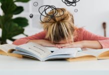 Help for Back-to-School Anxiety A girl slumped over books with scribbles drawn around her head