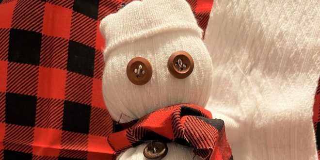 A snowman made from a sock. It has little button eyes. How cute!