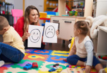 Schools Are Starting To Teach Social Emotional Learning … Teacher with boy and girl sitting on table having emotion therapy at kindergarten