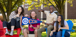 CCBC Students posing for a photo holding a CCBC banner.