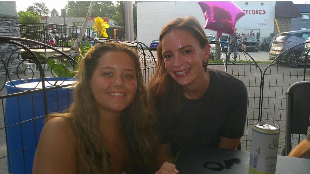 Two women posing and smiling