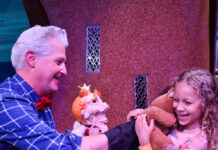 Performer Danny Joe and a little girl with a teddy bear