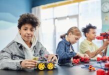 Children building small electric cars