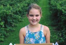 U-Pick Farms and Orchards in Maryland A girl holding a box of berries