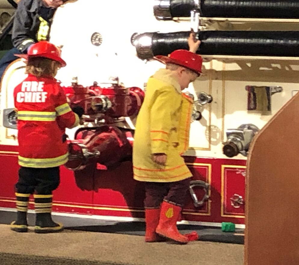 Children dressed in firefighter costumes at the Fire Museum of Maryland