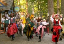 People dressed in costumes at a renaissance faire dancing