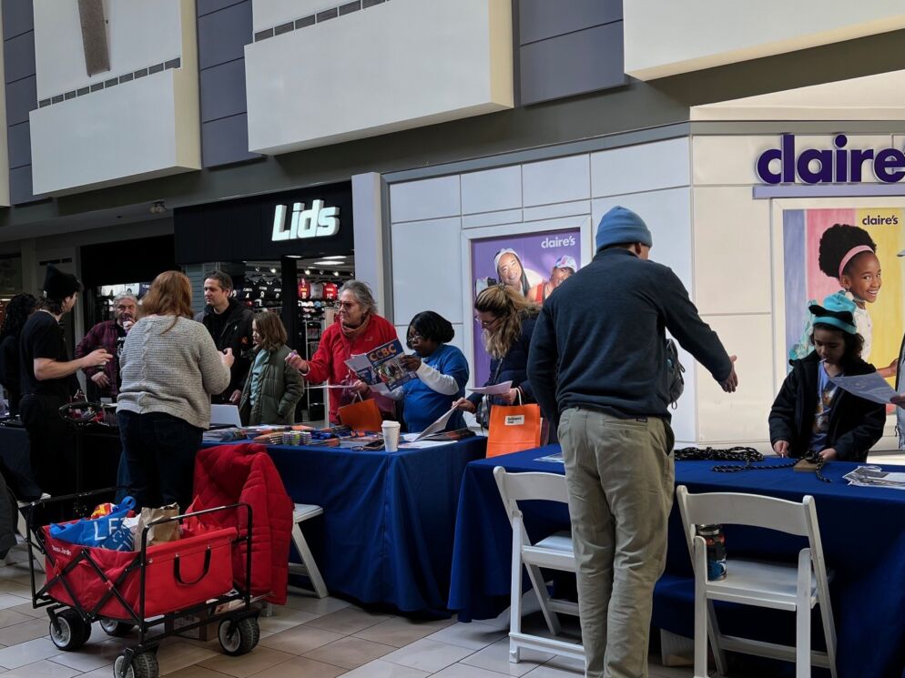 Crowd shot at Baltimore's Child Summer Camps & Activities Fair at Towson Town Center Feb. 7, 2026. Families peruse display tables at the fair.