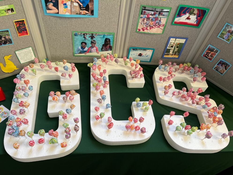 Letters spell out GCS for Glenelg Country School at a display table at Baltimore's Child's Summer Camps & Activities Fair.