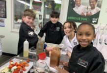 Young chefs from Young Chefs Academy in the kitchen