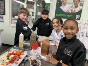 Young chefs from Young Chefs Academy in the kitchen
