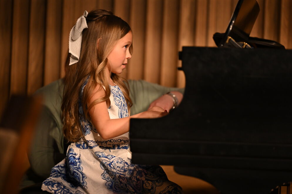 A young girl playing the piano 