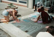 People drawing on the street with chalk