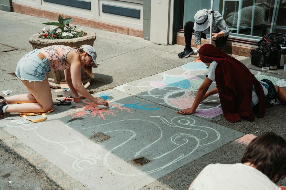 People drawing on the street with chalk
