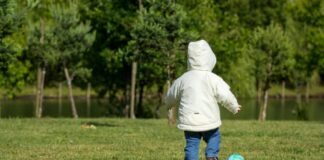 Boy kicking soccer ball alone
