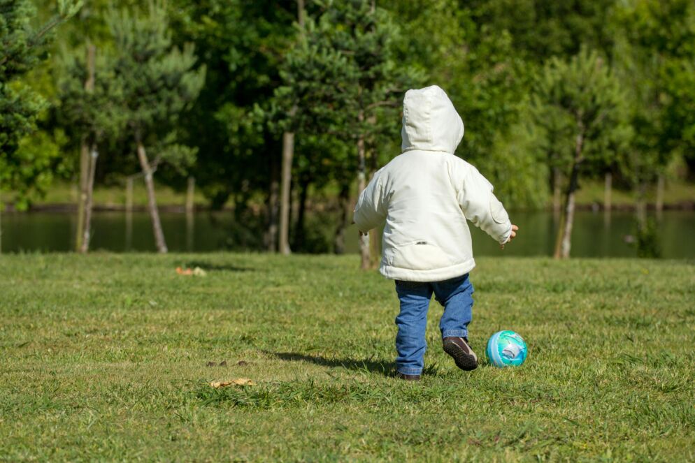 Boy kicking soccer ball alone