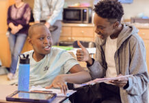 An aide helping a student