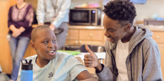 An aide helping a student