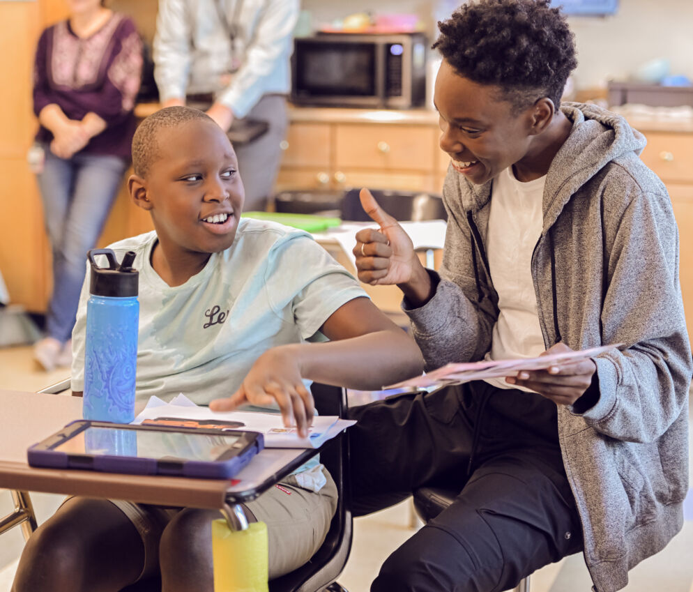 An aide helping a student