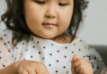 A girl touches a turtle