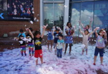 Children playing in foam at Mess Fest