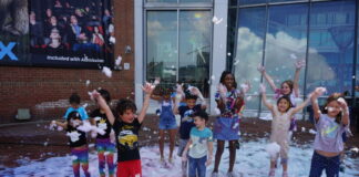 Children playing in foam at Mess Fest