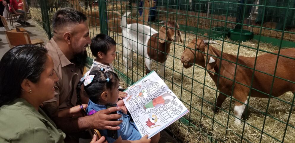 Kids gather around animals reading stories at the Maryland State Fair.