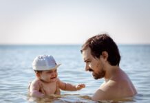 Beach Babes: Best Practices for Child Safety by the Ocean Father and baby by the water