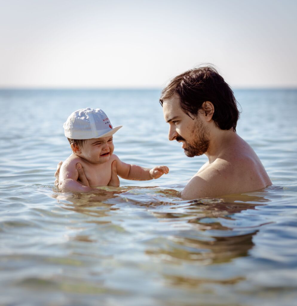 Father and baby by the water