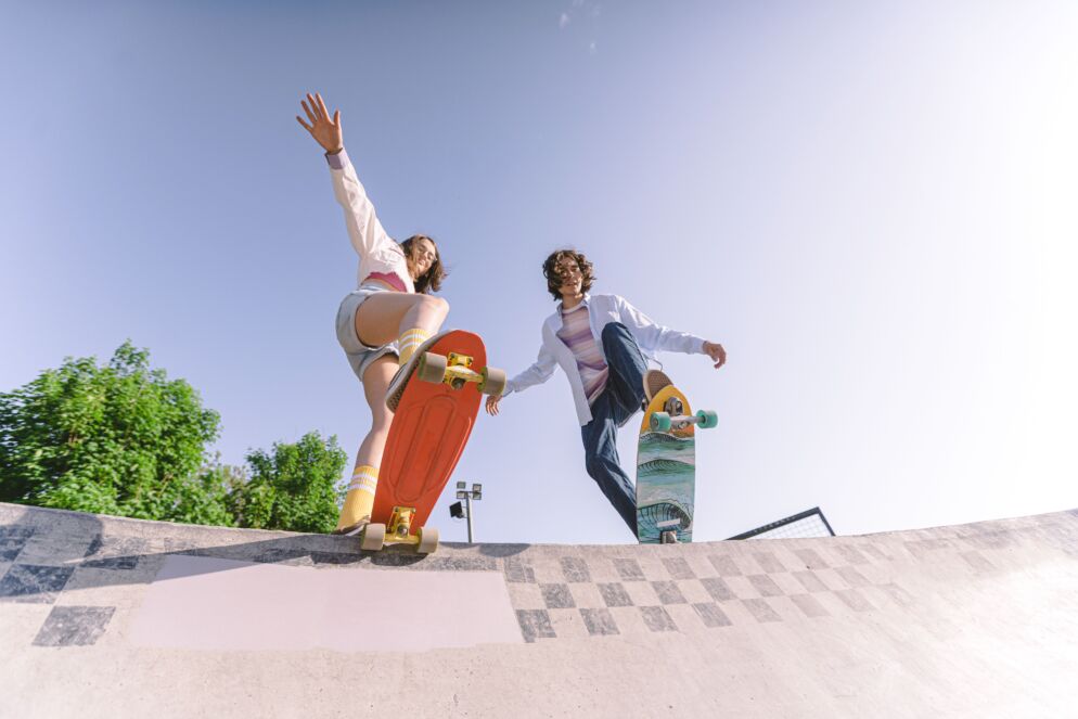 Teenagers skateboarding at a skate park