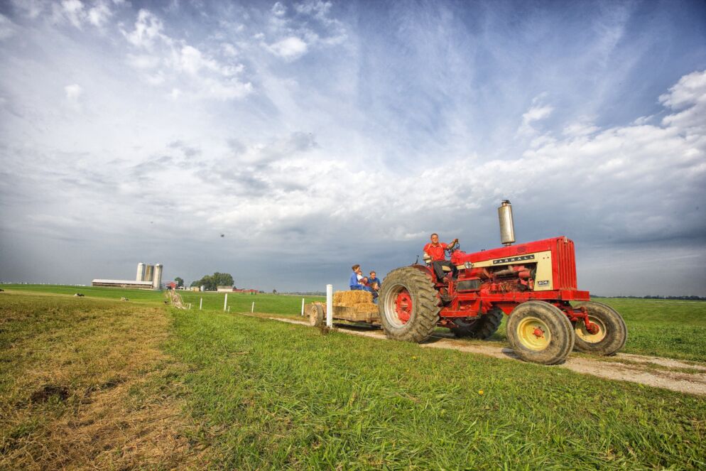 A tractor driving a hayride through a farm