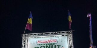 A large illuminated sign for Donut Burger at the Krispy Kreme stand at the fair