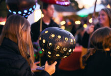 Person holding a decorated pumpkin
