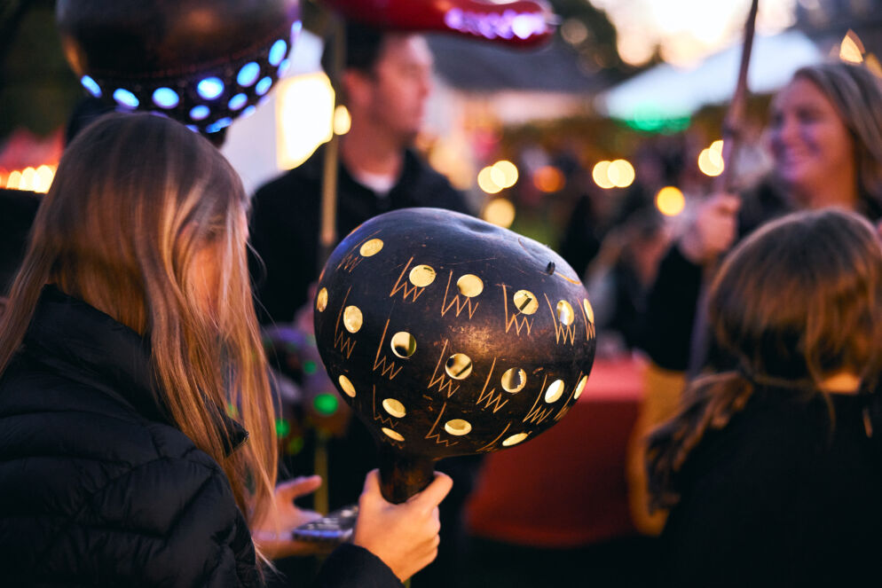 Person holding a decorated pumpkin