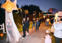 Things to Do in Baltimore This Weekend: Oct. 16-18 People walking in a parade at Garden Glow