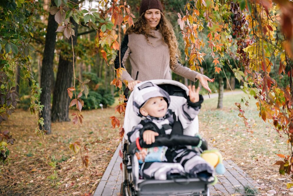Woman walking with a baby in a stroller