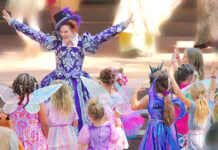 Immersive Play: Renaissance Road Trip A woman surrounded by children dressed as fairies