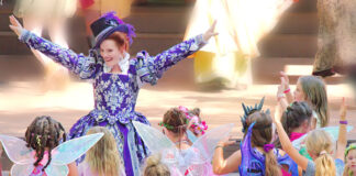 A woman surrounded by children dressed as fairies