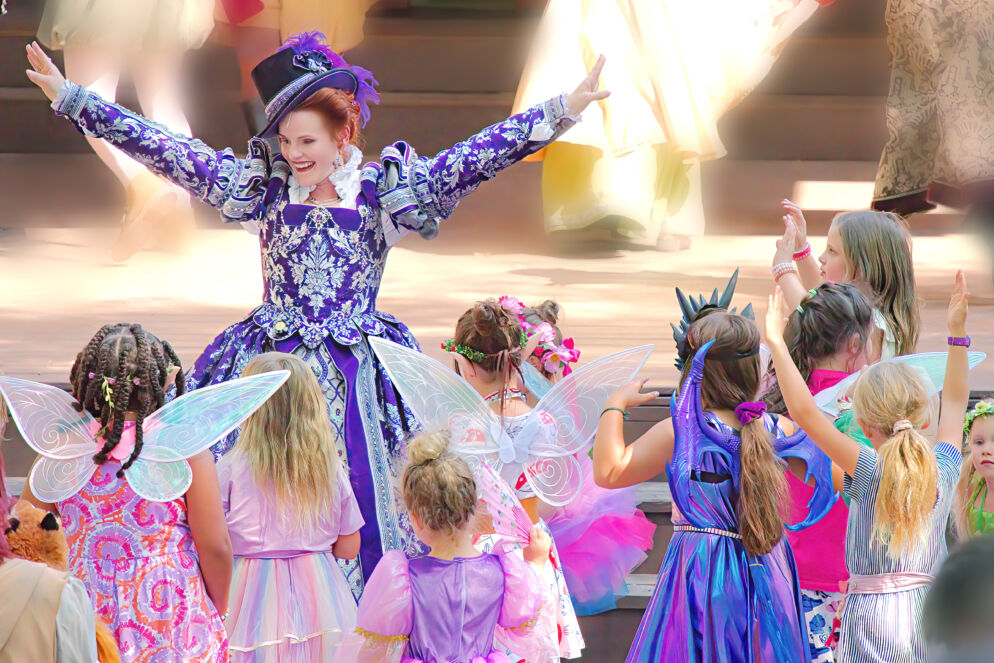 A woman surrounded by children dressed as fairies