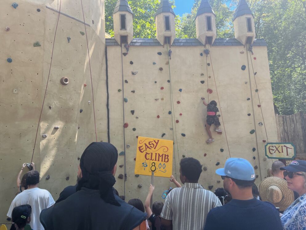 people climbing a rock wall