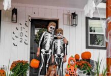 A family with two dogs all dressed up in Halloween costumes