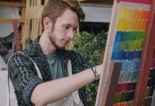 An artist working on a painting in a studio